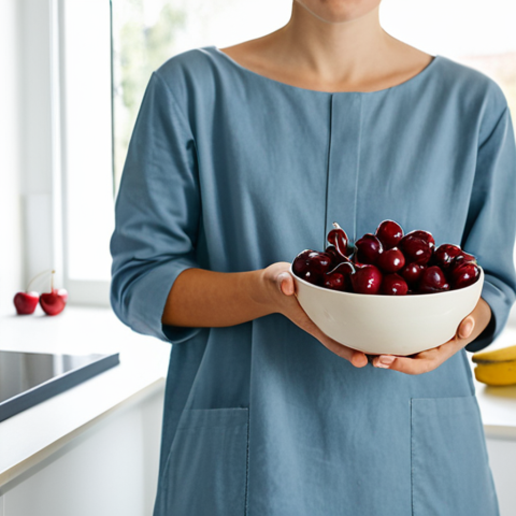 A serene person, gender-neutral and adult, in comfortable, modest clothing, gently holding a small bowl of fresh cherries. The setting is a tranquil, well-lit modern kitchen, with a clean counter displaying other sleep-friendly foods such as almonds and a banana. Soft, warm evening light filters through a window, creating a calm and inviting atmosphere. Professional photography, high detail, perfect anatomy, correct proportions, natural pose, well-formed hands, proper finger count, natural body proportions, fully clothed, appropriate attire, modest clothing, safe for work, appropriate content, family-friendly.
